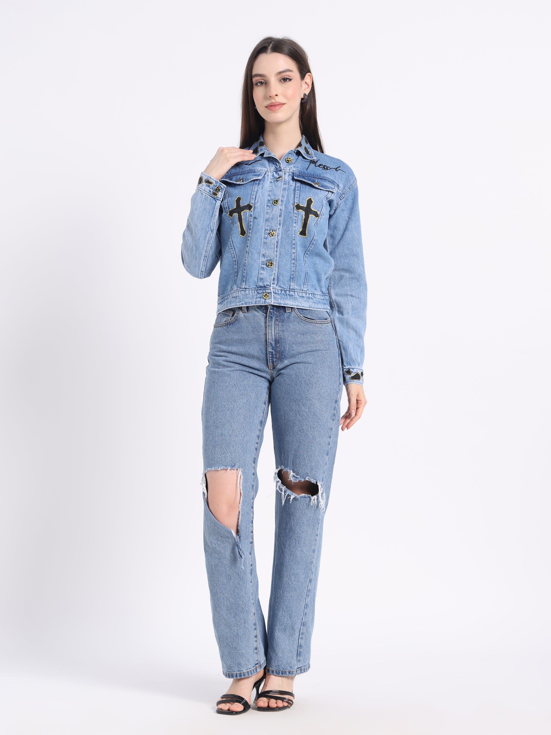 Gotamoda Christian artwear denim jacket with cross embellishments, styled with ripped jeans and open-toe sandals