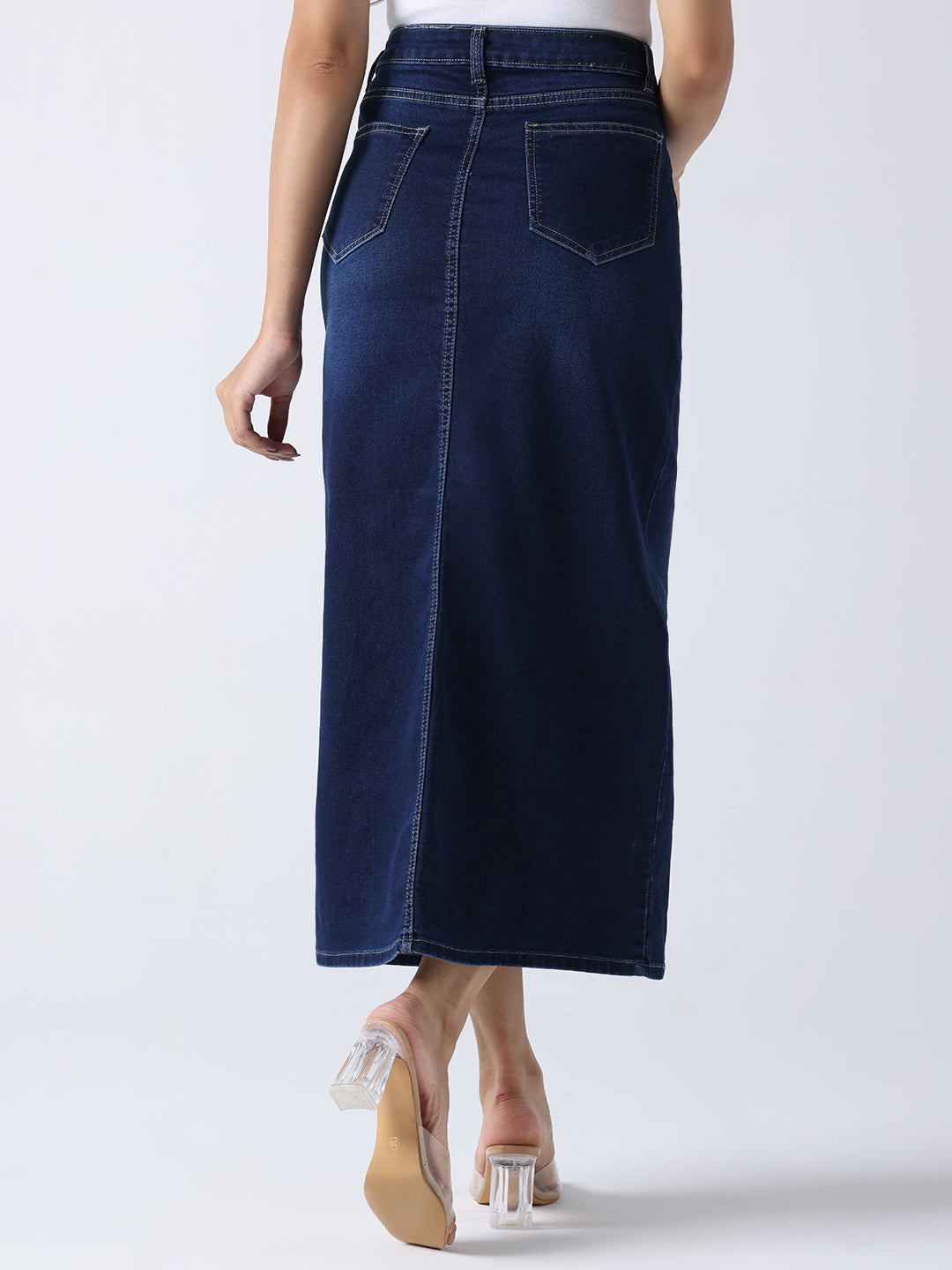 Back view of woman wearing Daisy Dream Denim front cut Skirt in dark blue with pockets and mid-length design