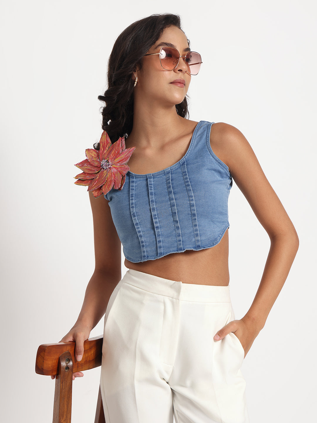 Gotamoda stylish sleeveless blue jeans top worn with white pants and sunglasses