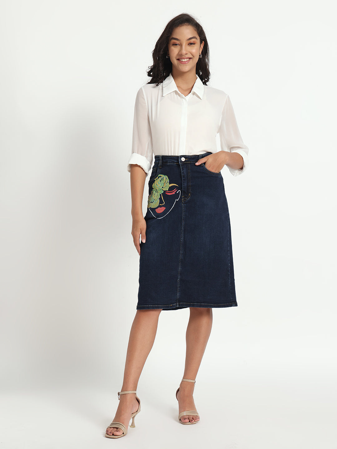 Gotamoda dark blue denim skirt with embroidered design worn with white shirt and heels