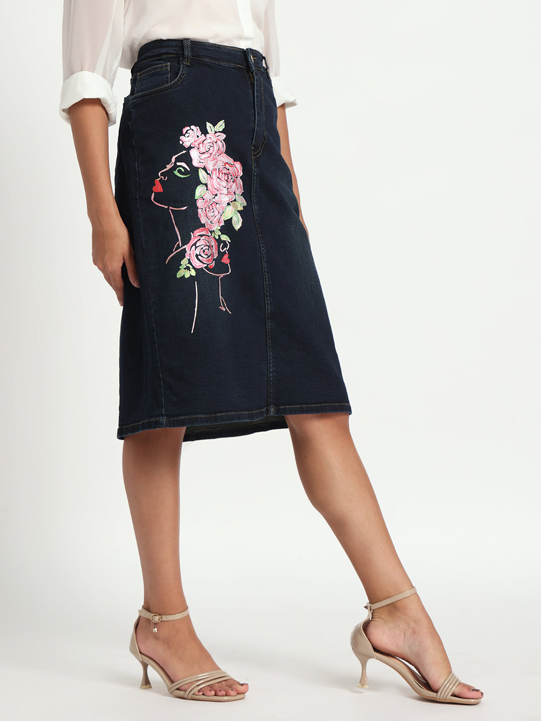 Gotamoda dark blue denim skirt with floral embroidery on side, worn with white blouse and beige heels