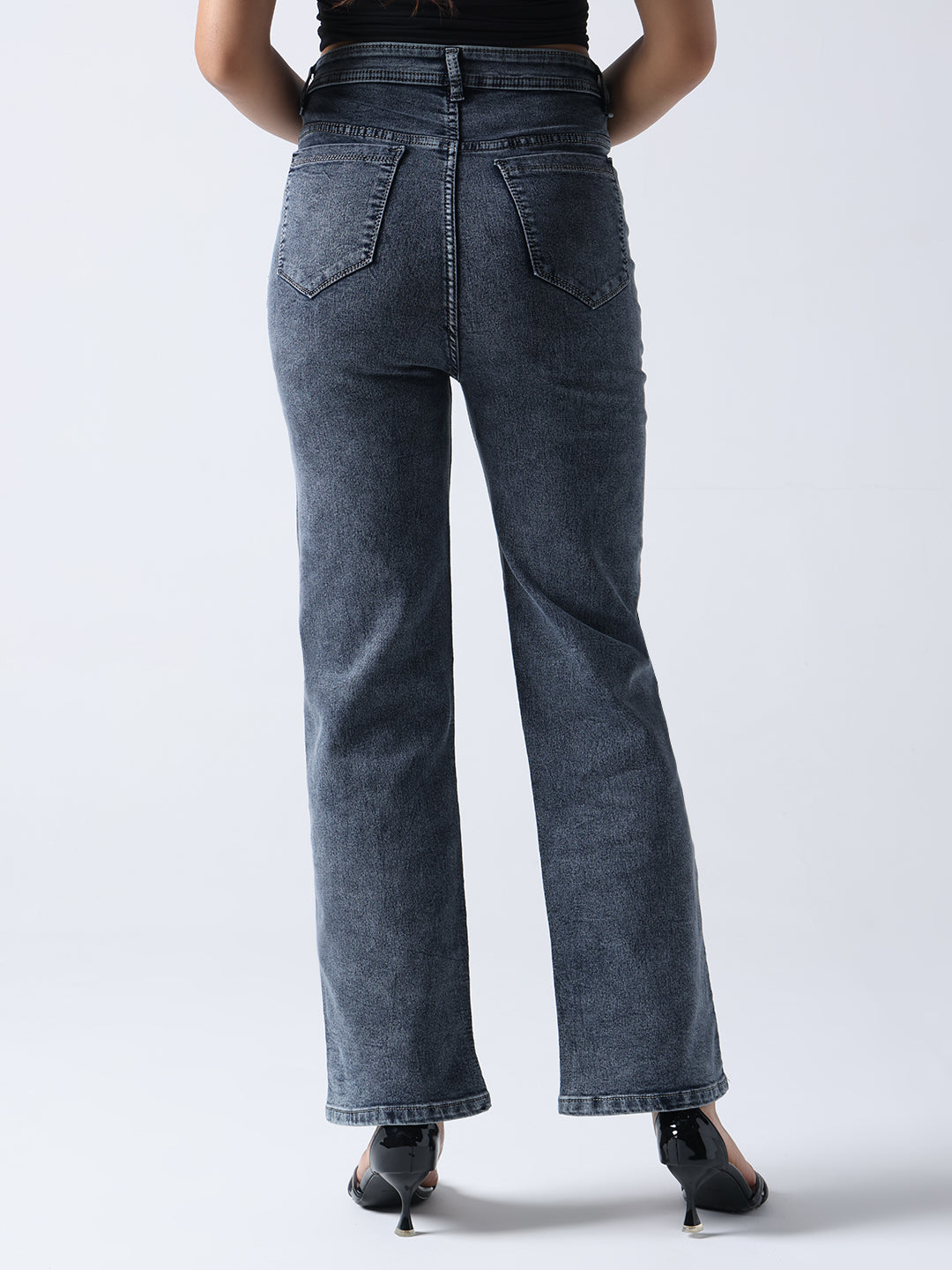 Back view of Gotamoda hand painted jeans in dark washed denim worn with black heels