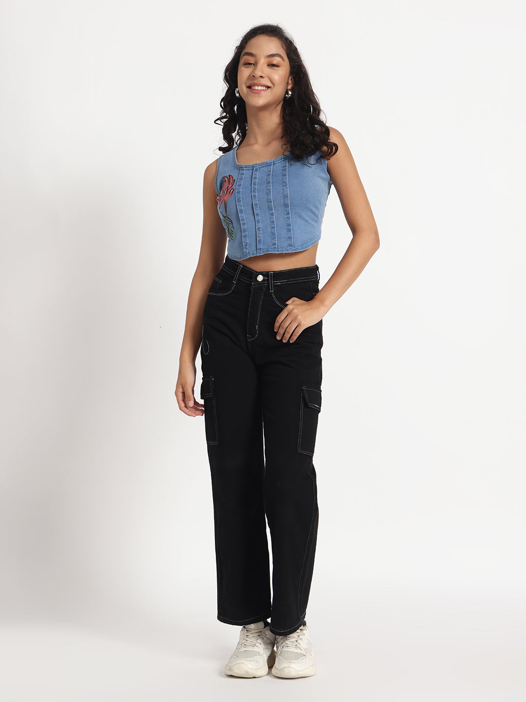 Gotamoda Jeans Crop Top in blue denim with floral embroidery worn by smiling woman with black cargo pants