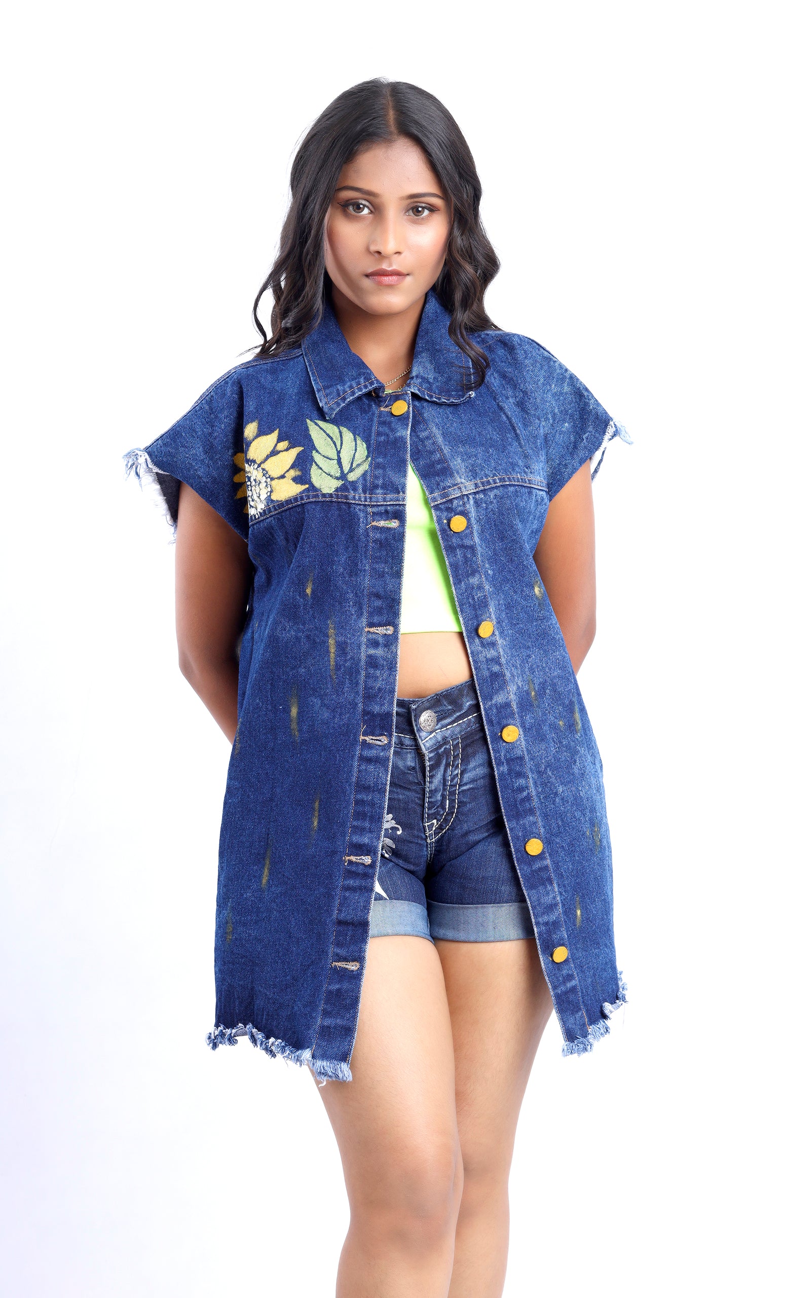 Gotamoda sleeveless denim jacket with floral print and frayed edges worn over casual shorts