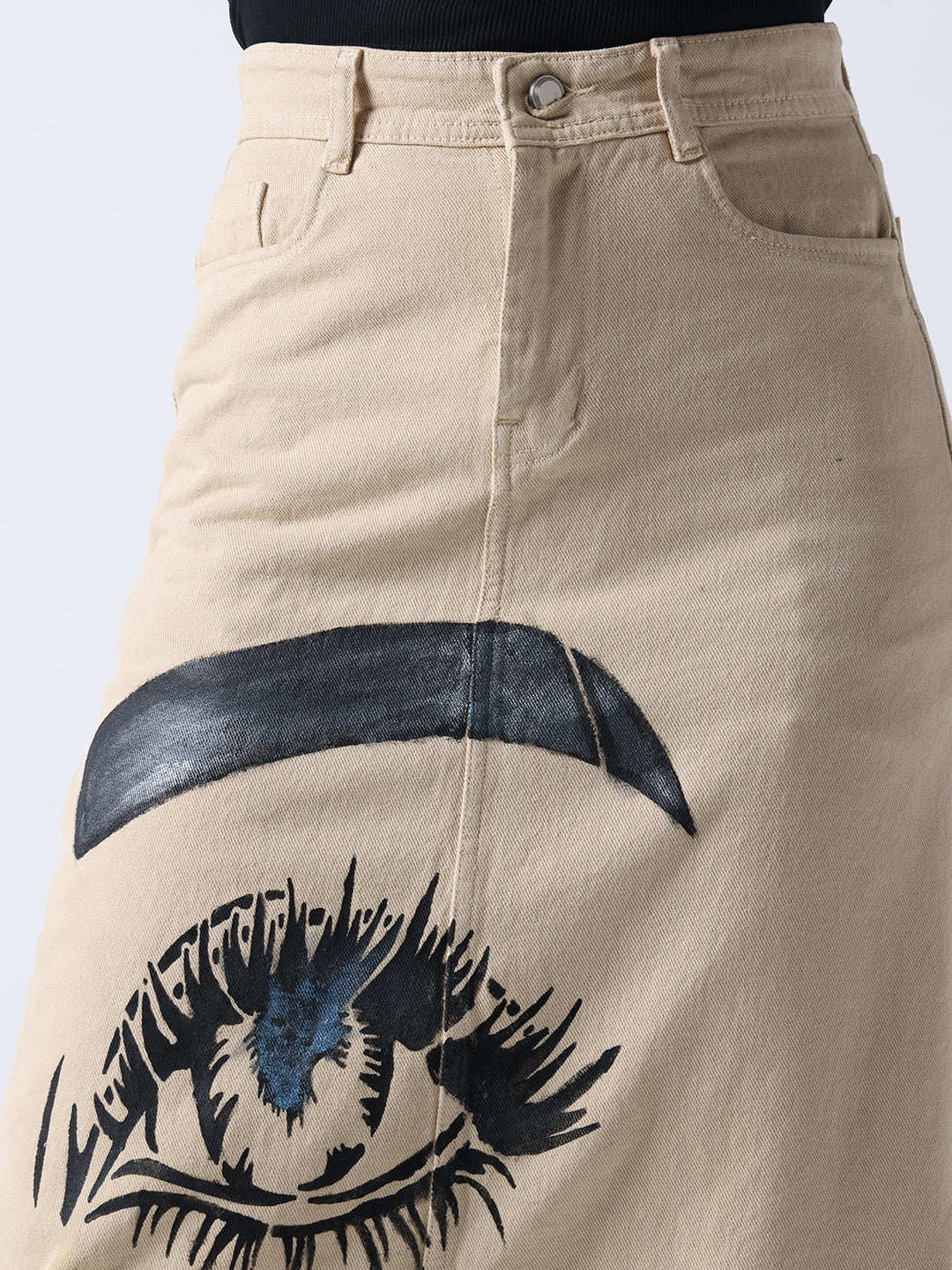 Pop Art Glam Hand Painted Denim Skirt in beige featuring a large black and blue eye design on the front