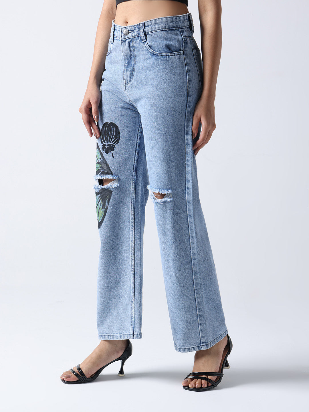 Gotamoda light blue hand painted jeans with floral design and ripped knees worn with black heels