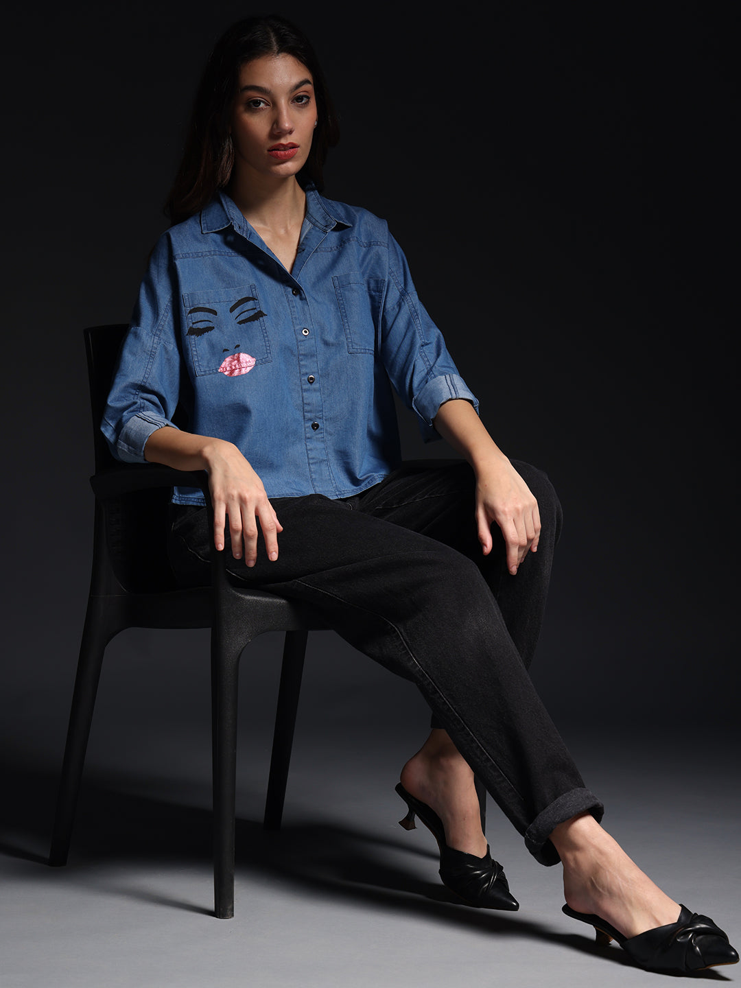 Gotamoda top jeans shirt blue denim with face graphic worn by woman seated on black chair