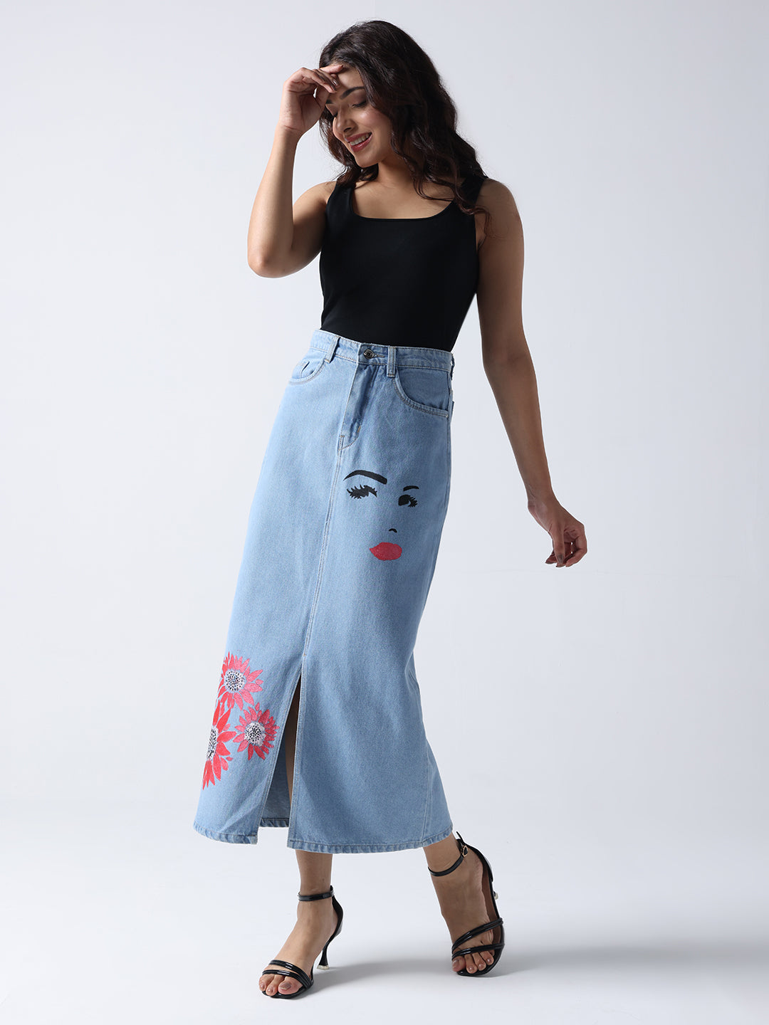 Winking Beauty Denim Hand Painted Denim Skirt with artistic face and floral designs worn with black sleeveless top and heels
