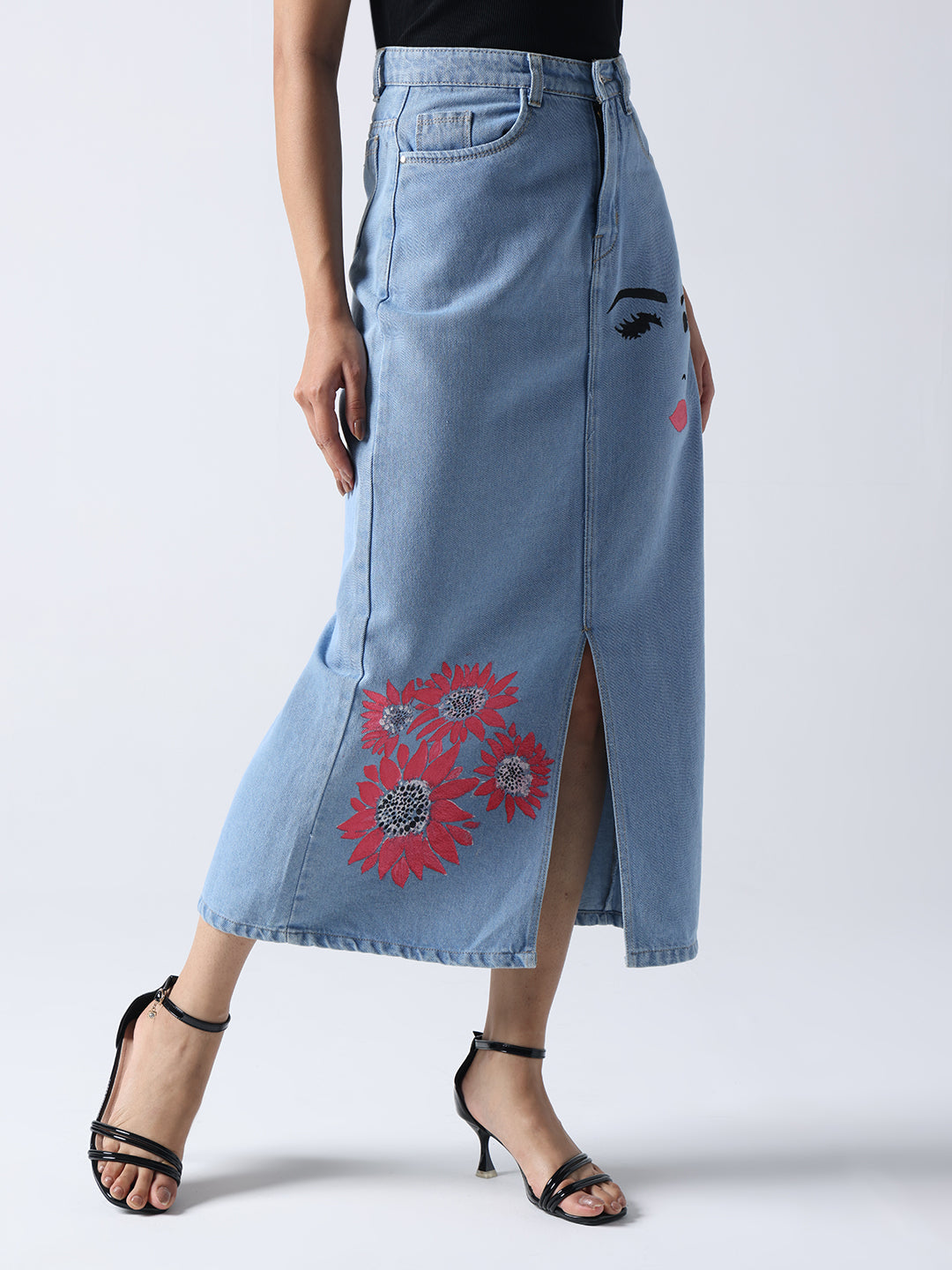 Winking Beauty Denim Hand Painted Denim Skirt with red floral and face design, front slit, styled with black strappy heels