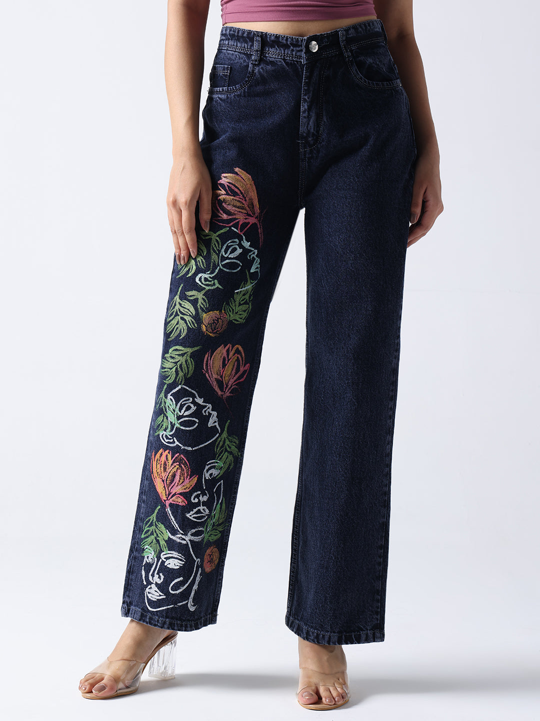 Dark denim Hand Painted Jeans with colorful floral and face art design on one leg Hand Painted Jeans