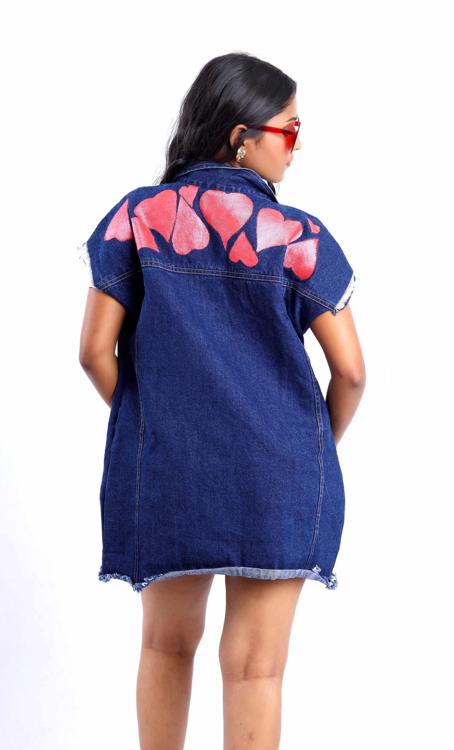 Gotamoda sleeveless denim jacket featuring distressed hem and pink heart designs on the back