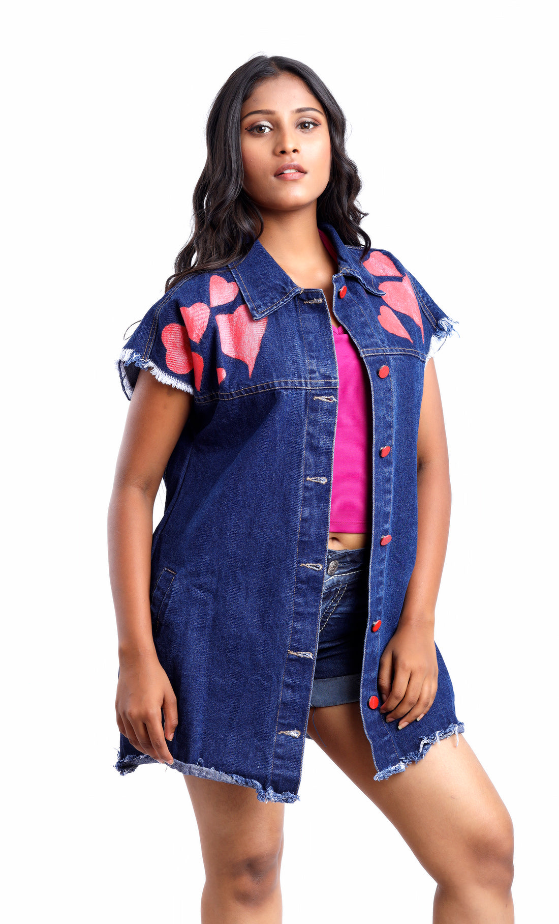 Gotamoda sleeveless denim jacket with heart patches worn over pink top and denim shorts