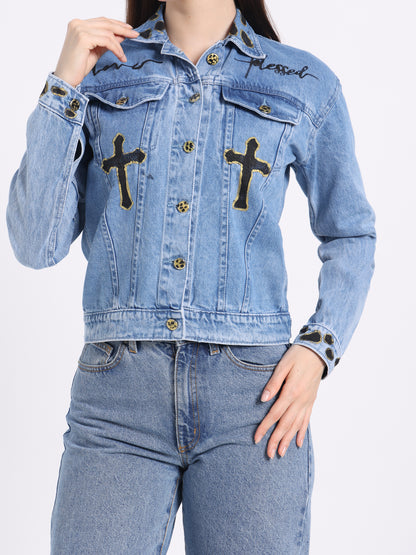 Denim jacket featuring gold cross accents and &