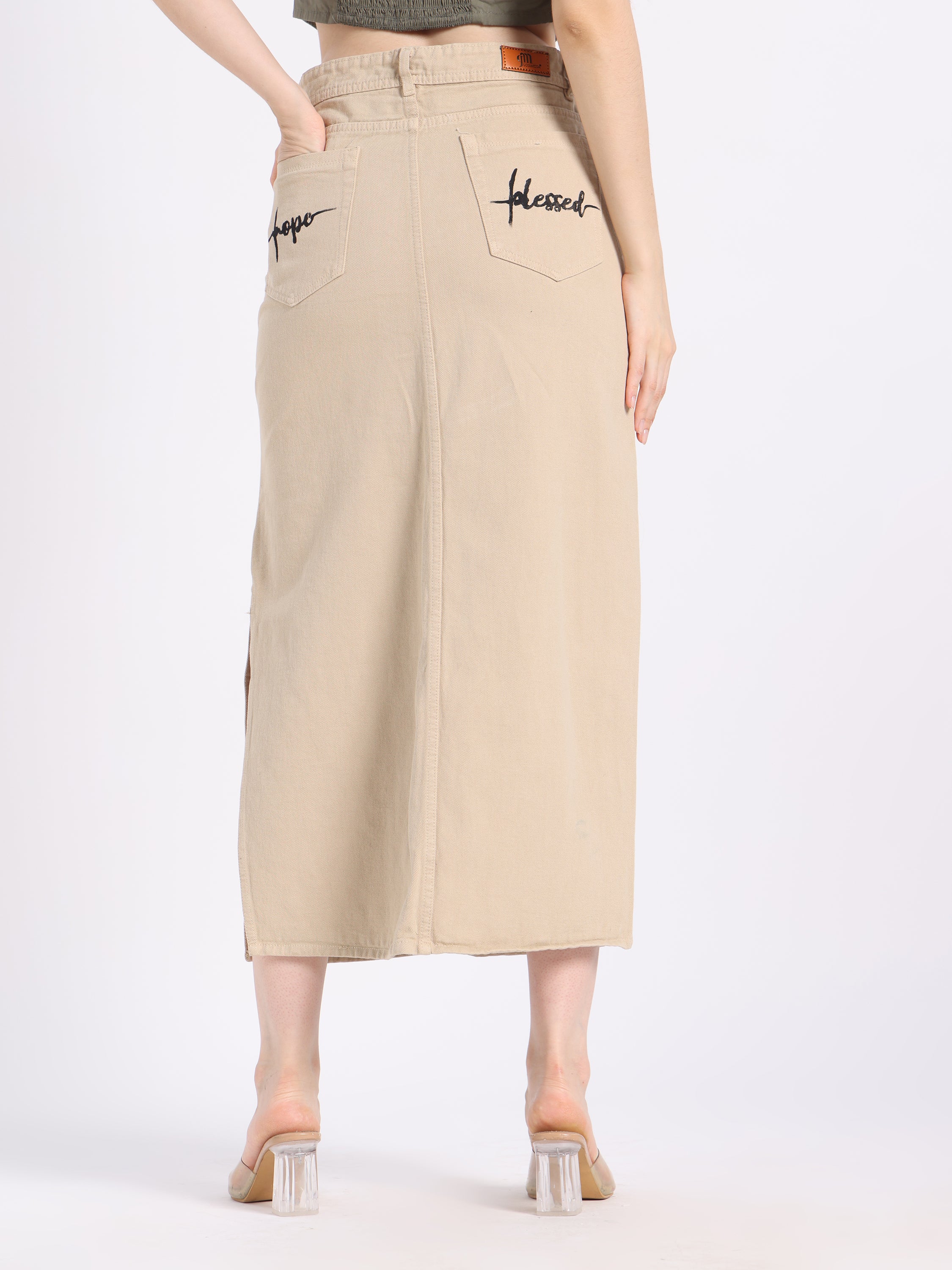Back view of a beige Christian modest skirt by gotamoda with embroidered &