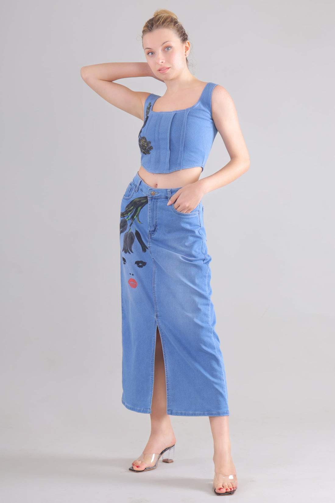 Gotamoda denim corset co-ord set featuring a sleeveless corset top and a high-waist skirt with artistic face print