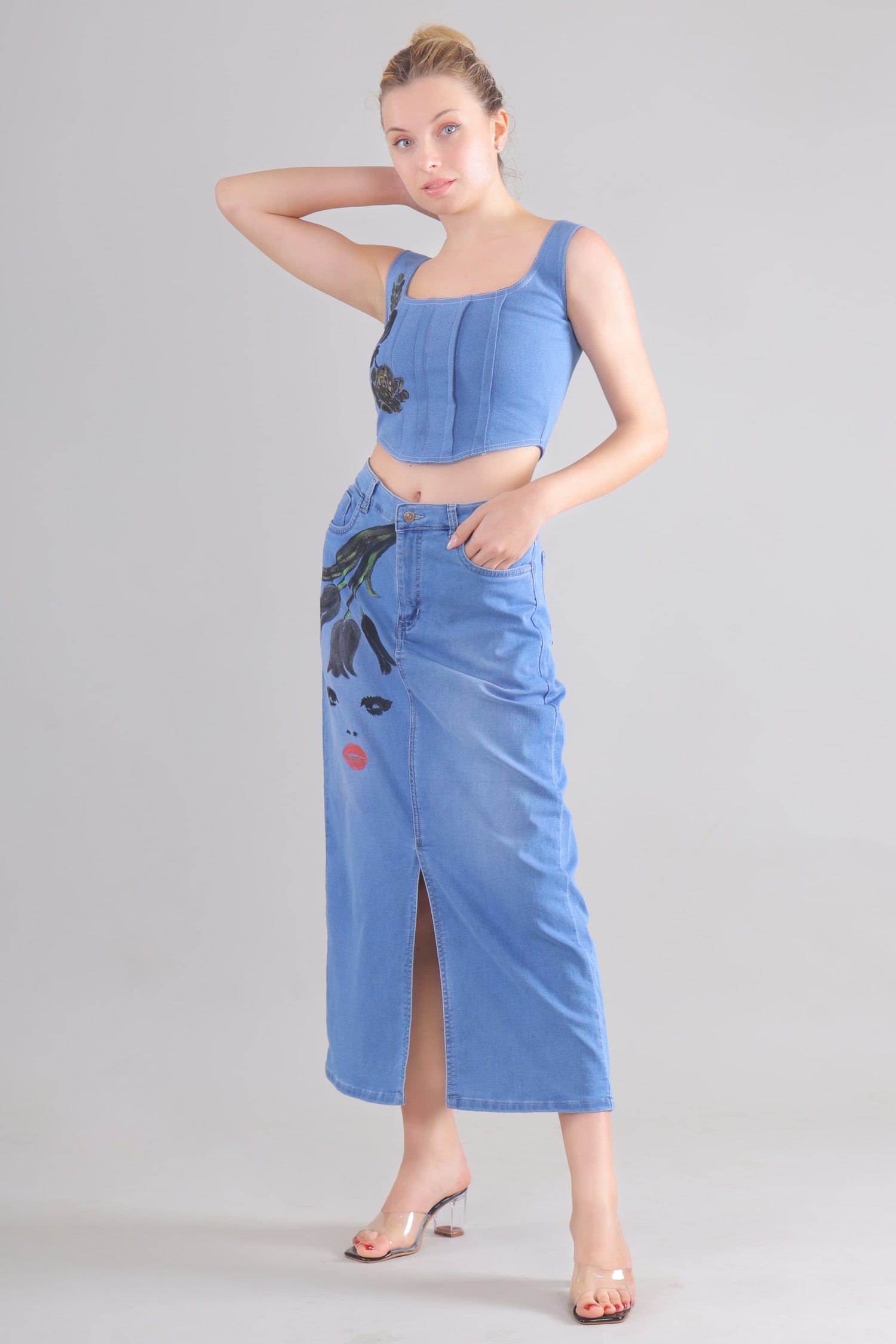 Gotamoda denim corset co-ord set featuring a sleeveless corset top and a high-waist skirt with artistic face print