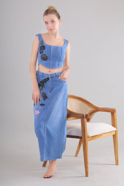 Gotamoda denim corset co-ord set featuring a sleeveless cropped top and long denim skirt with floral and face print
