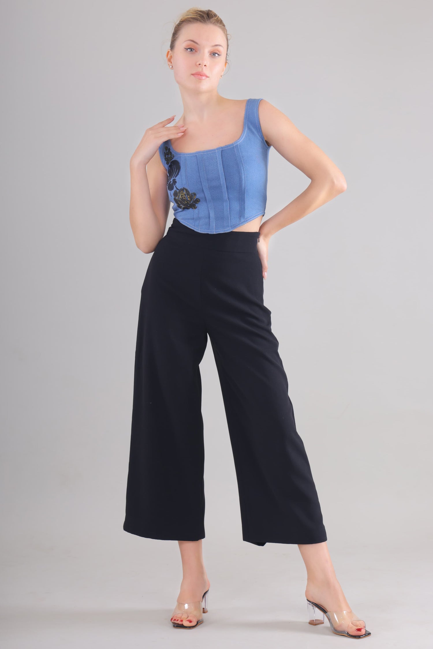 Gotamoda Denim Corset Top in blue with floral embroidery paired with black wide-leg pants