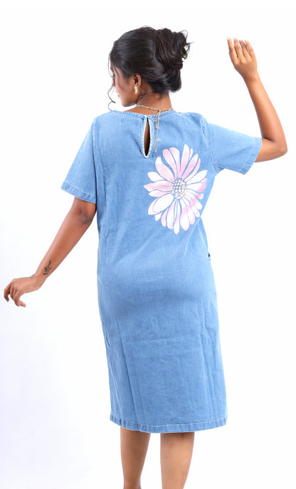 Back view of woman wearing blue denim midi dress with pink flower design by Gotamoda