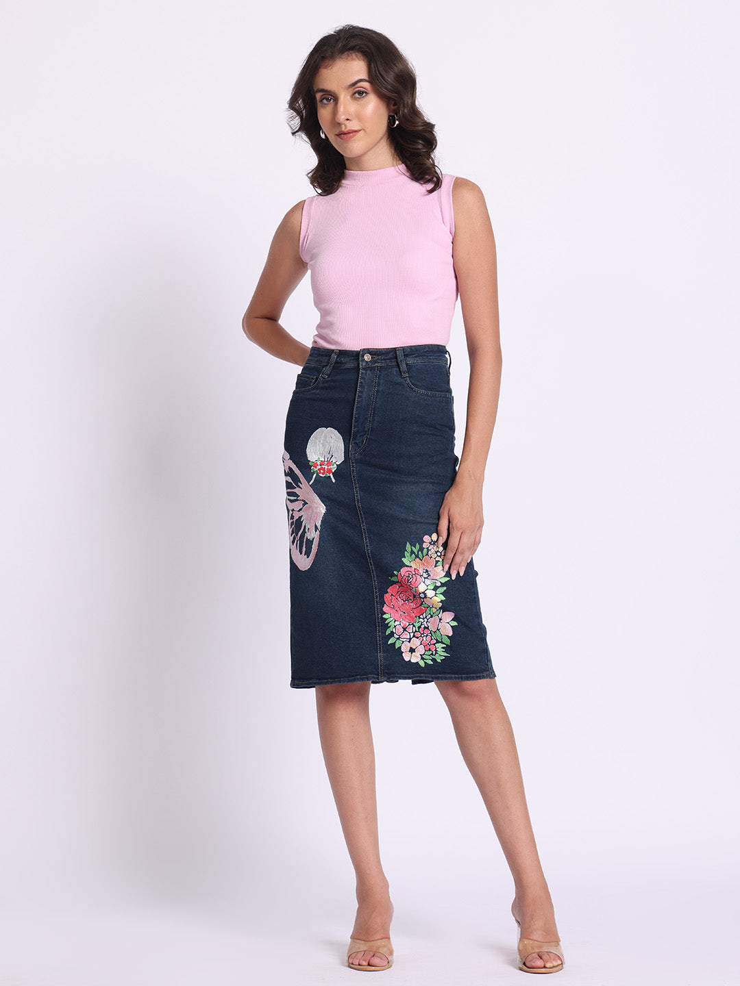 Gotamoda dark blue Denim Skirt with floral and butterfly embroidery worn by woman in pink sleeveless top