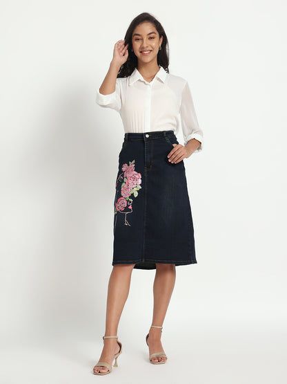 Gotamoda dark blue denim skirt with pink floral embroidery worn with white blouse and heels