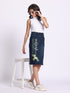 Gotamoda denim skirt with floral print and text detail worn with white sleeveless top and sneakers