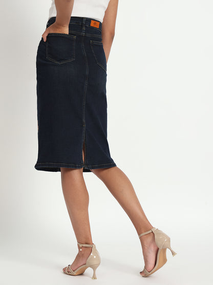 Back view of hand-painted denim skirt by Gotamoda worn with beige heels and white top