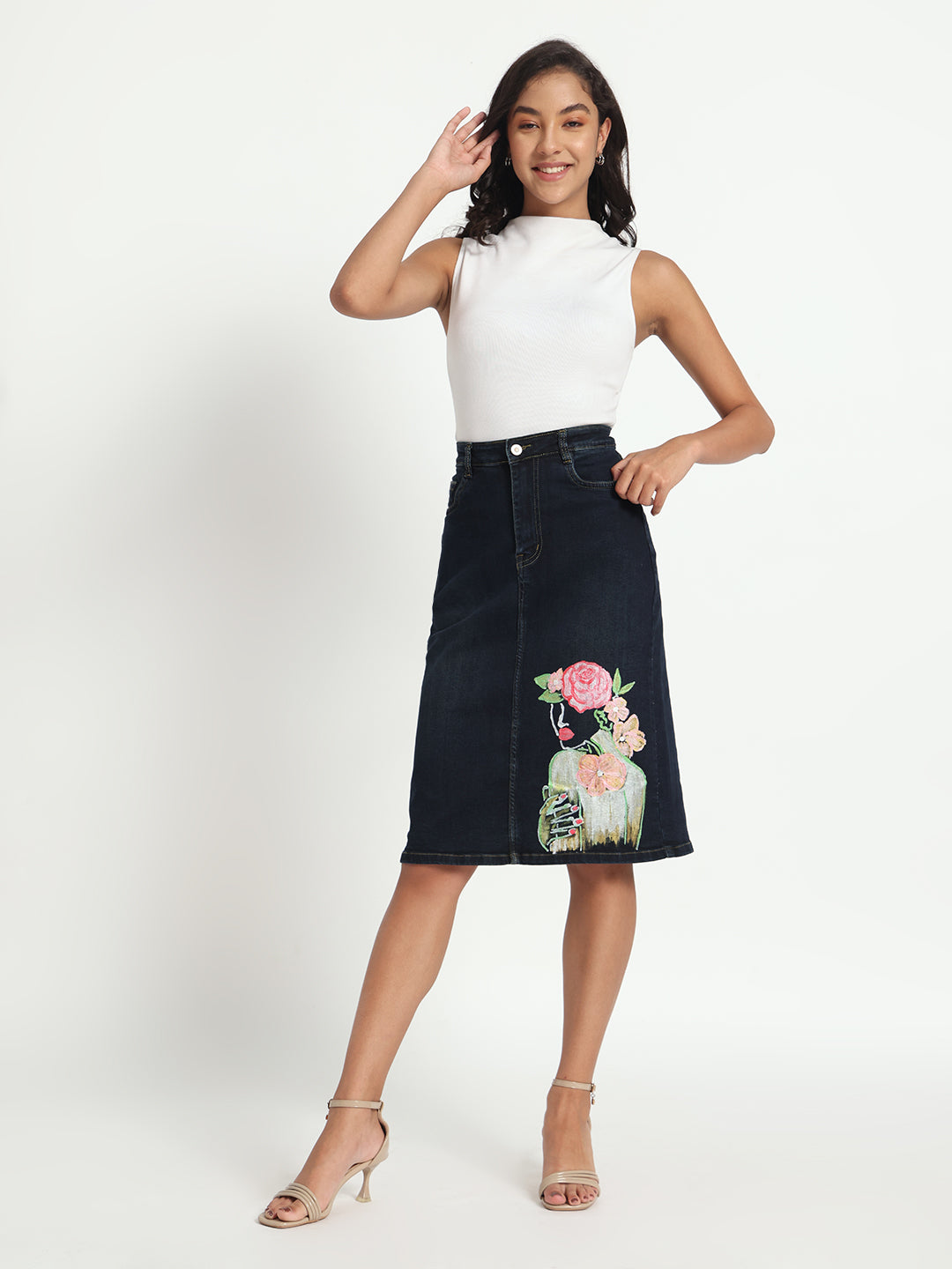 Gotamoda hand-painted denim skirt with floral design worn with white sleeveless top and heels