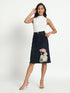 Gotamoda hand-painted denim skirt with floral design worn with white sleeveless top and heels