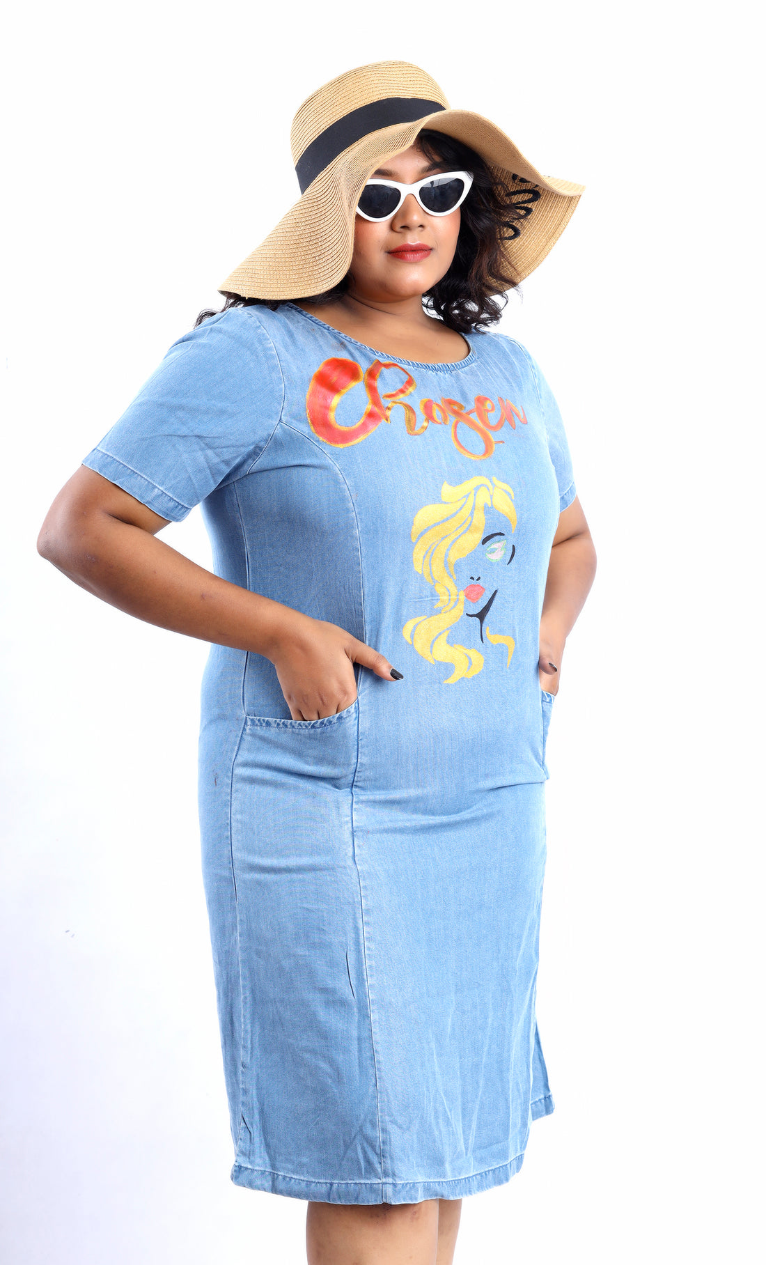 Gotamoda plus size denim dress with graphic print, short sleeves, and front pockets worn with sunhat and sunglasses
