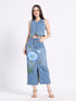 Stylish model wearing a hand-painted denim co-ord set featuring floral designs and a slit skirt