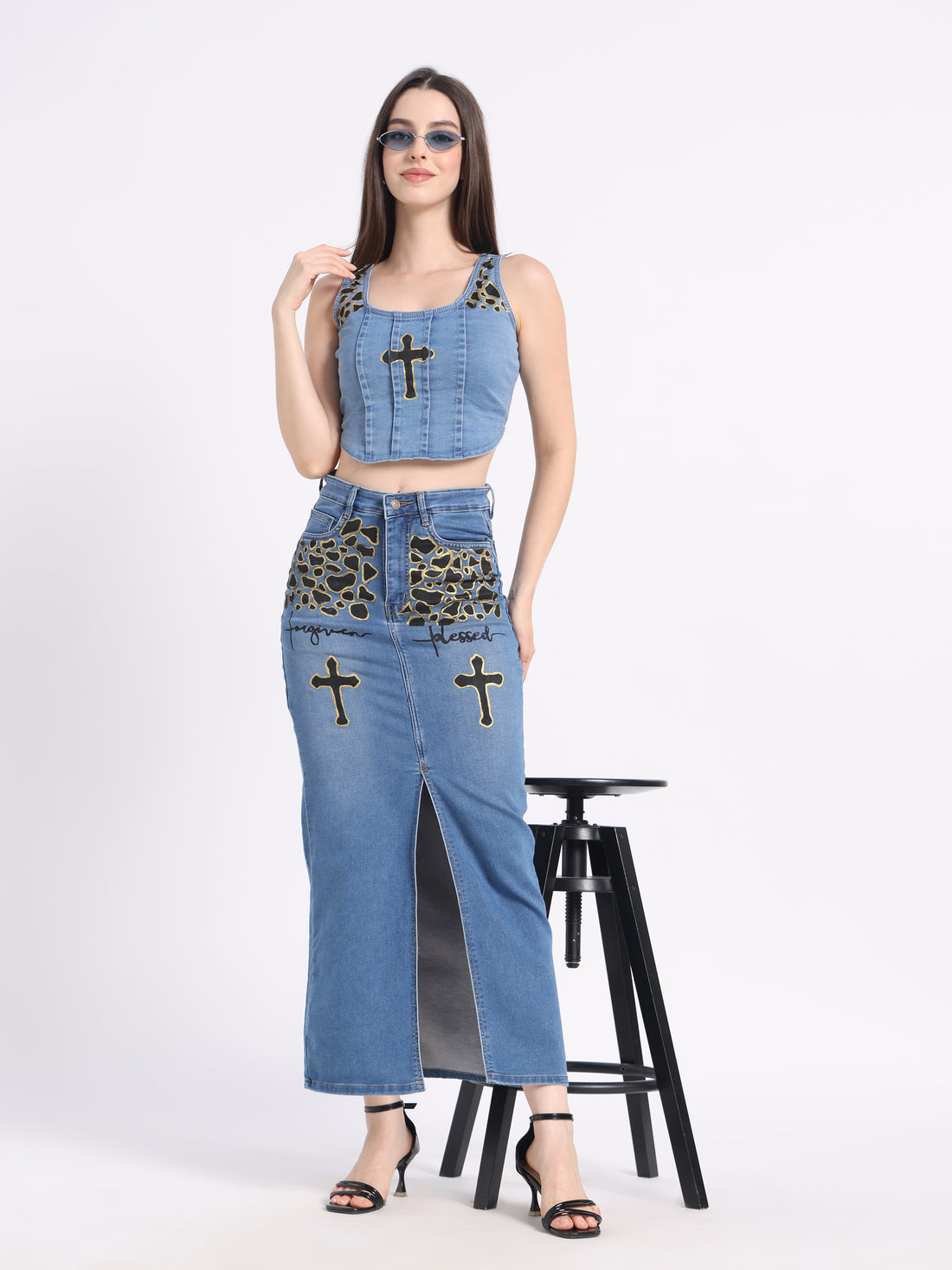 Model wearing a hand-painted denim co-ord set featuring crop top and long skirt with unique designs