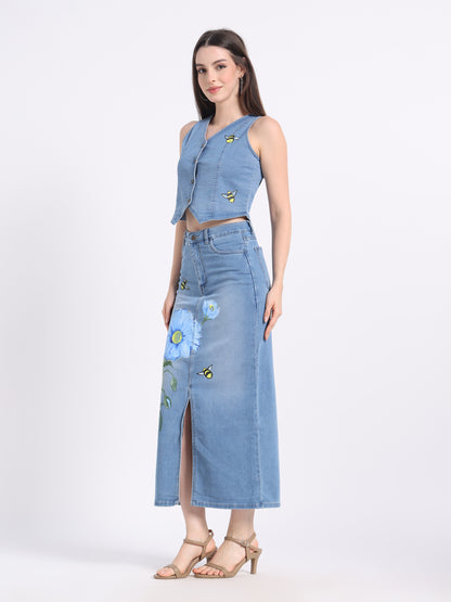 Stylish model wearing a hand-painted denim co-ord set featuring floral designs on the skirt
