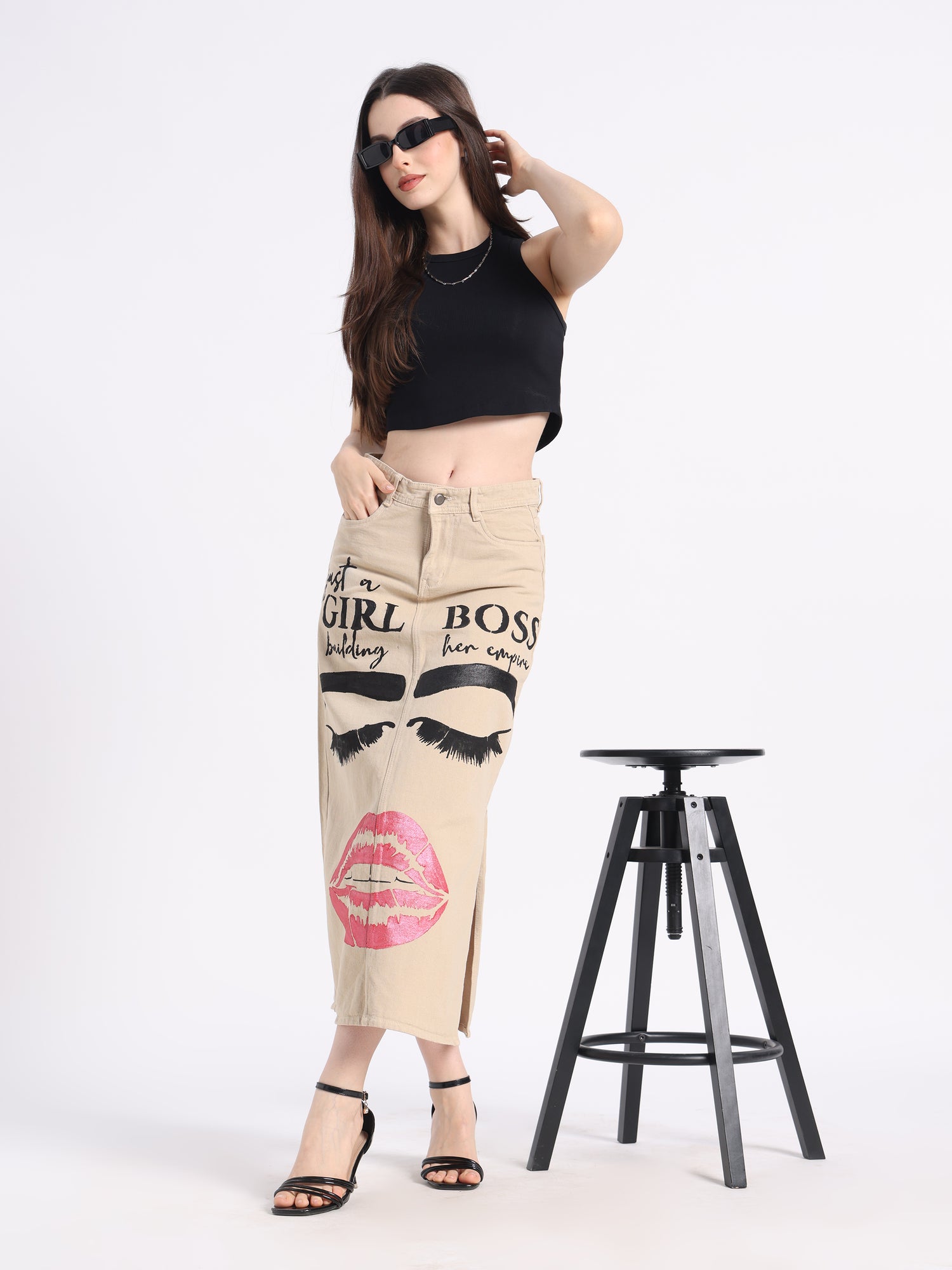 Fashionable hand-painted denim skirt featuring bold lips and eyelash designs for a trendy look