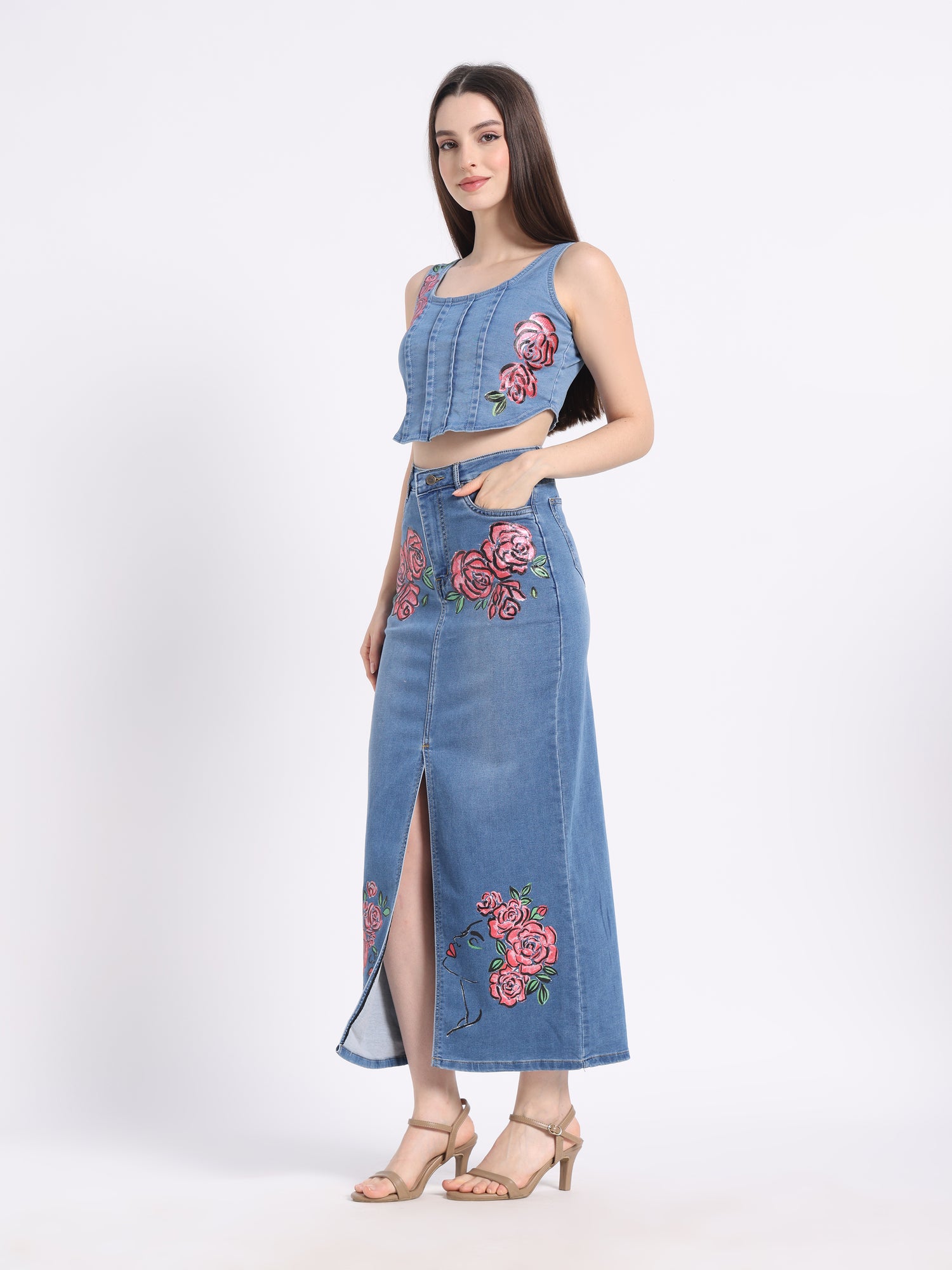 Stylish model wearing a hand-painted floral denim co-ord set featuring a crop top and skirt