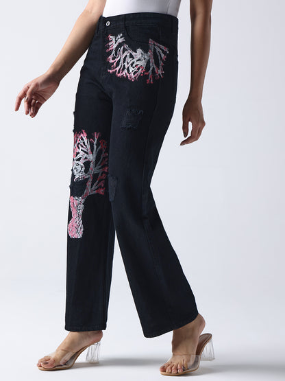 Gotamoda black hand painted jeans with abstract pink and white designs worn with clear heels