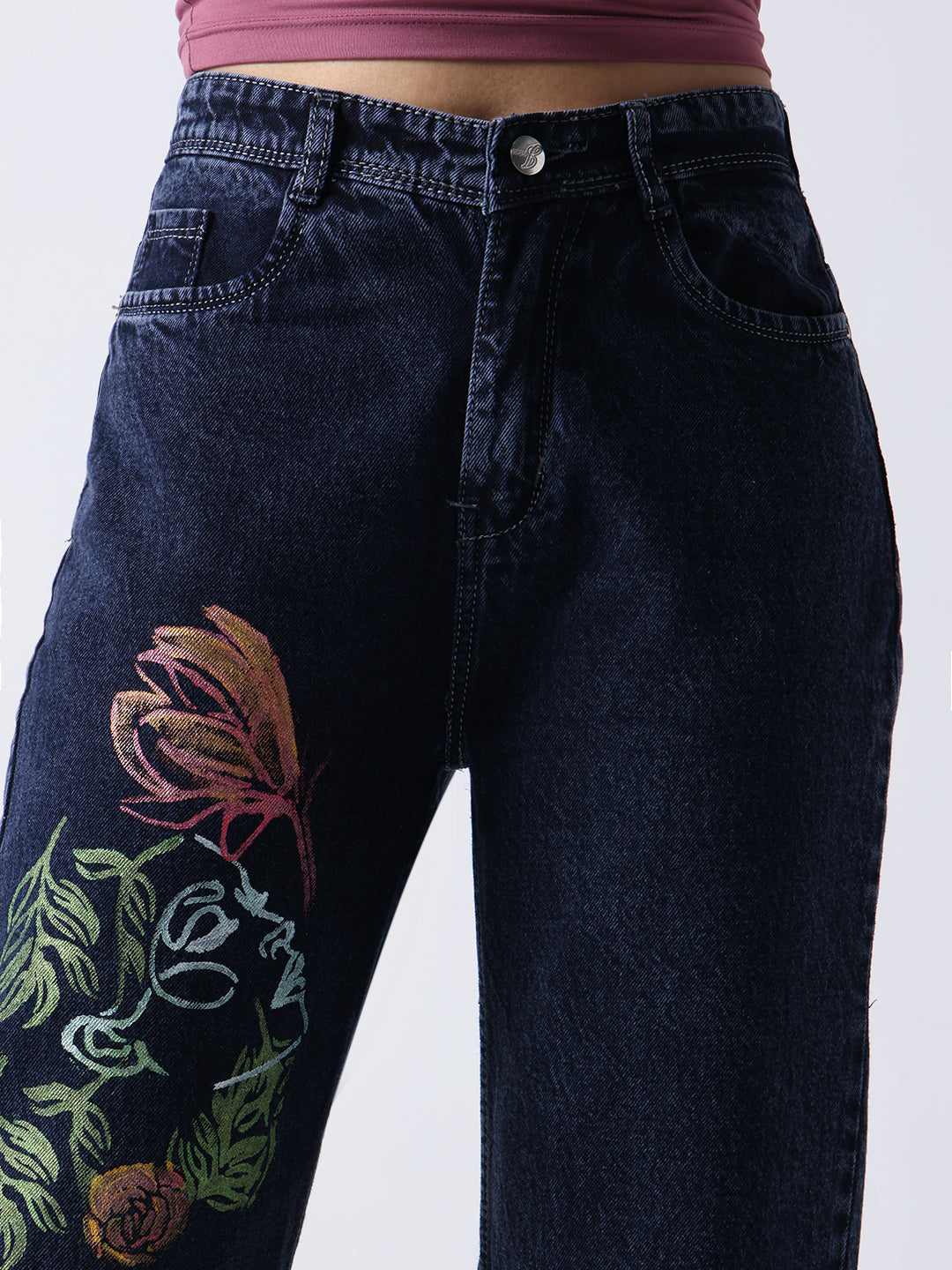 Gotamoda hand painted jeans in dark denim with colorful floral and face artwork on left thigh