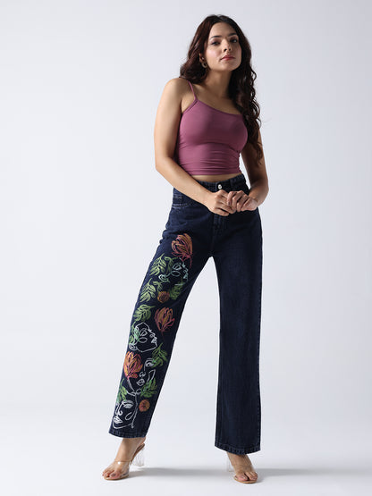 Gotamoda hand painted jeans with colorful floral designs worn by a woman in a purple tank top