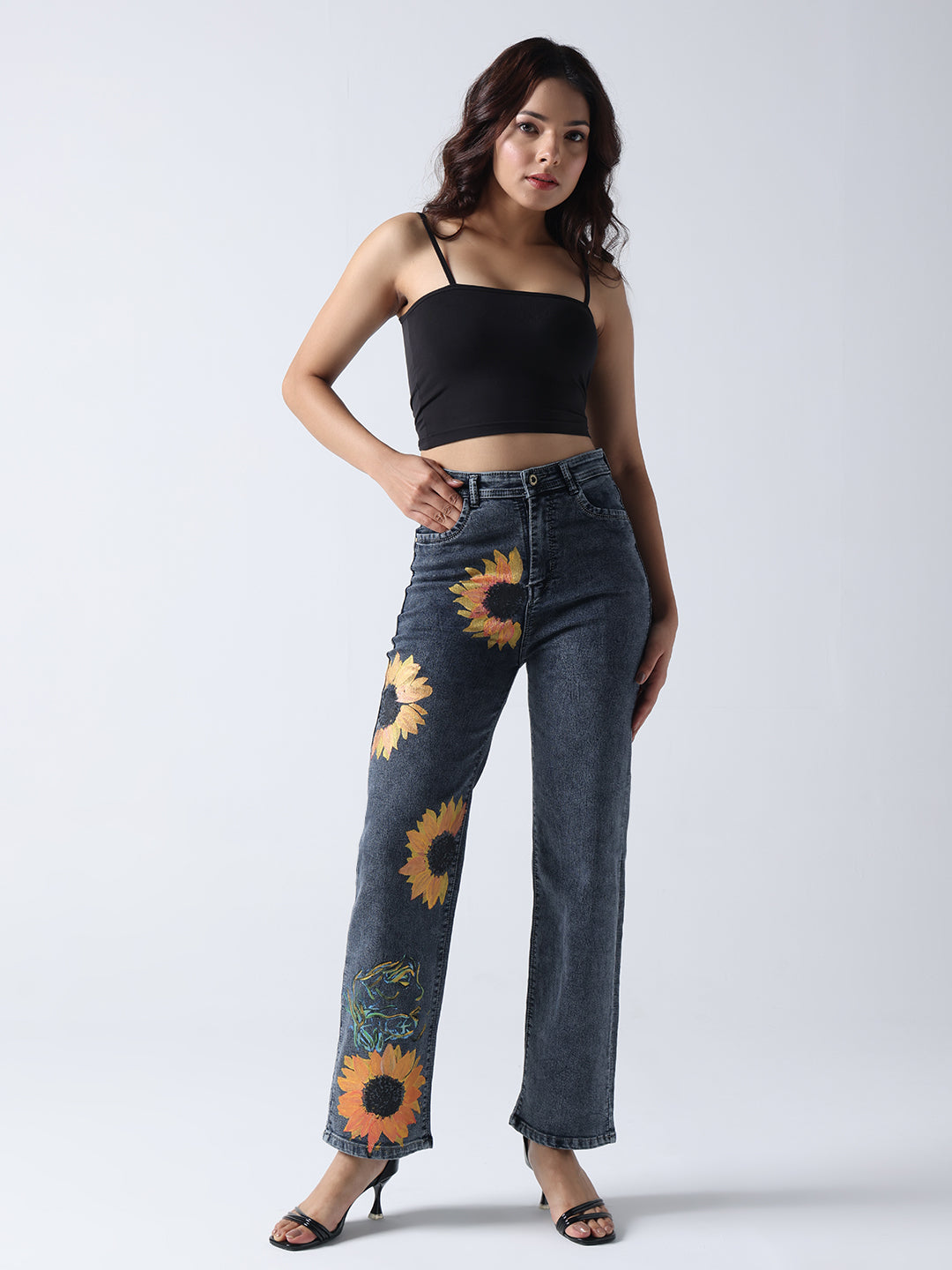 Gotamoda hand painted jeans with sunflower design worn with black crop top and heels