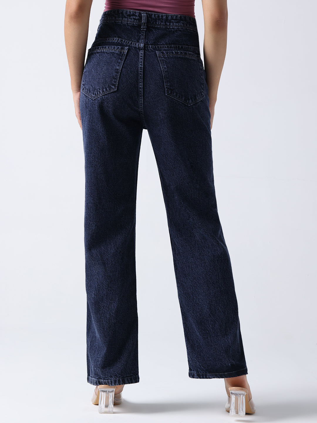 Back view of dark blue high-waisted hand painted jeans by Gotamoda worn with beige heels