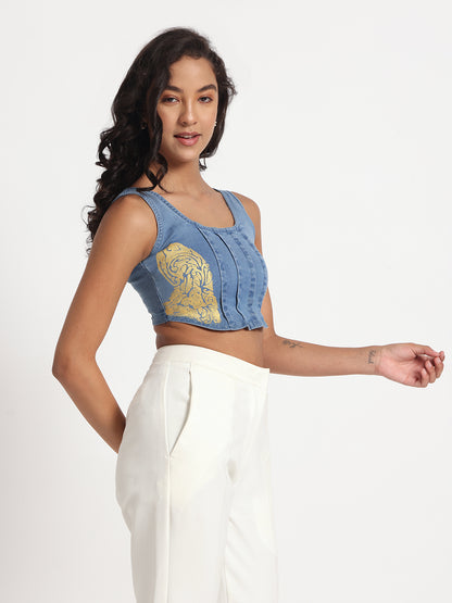 Gotamoda blue sleeveless jeans top with yellow tiger print worn with white pants