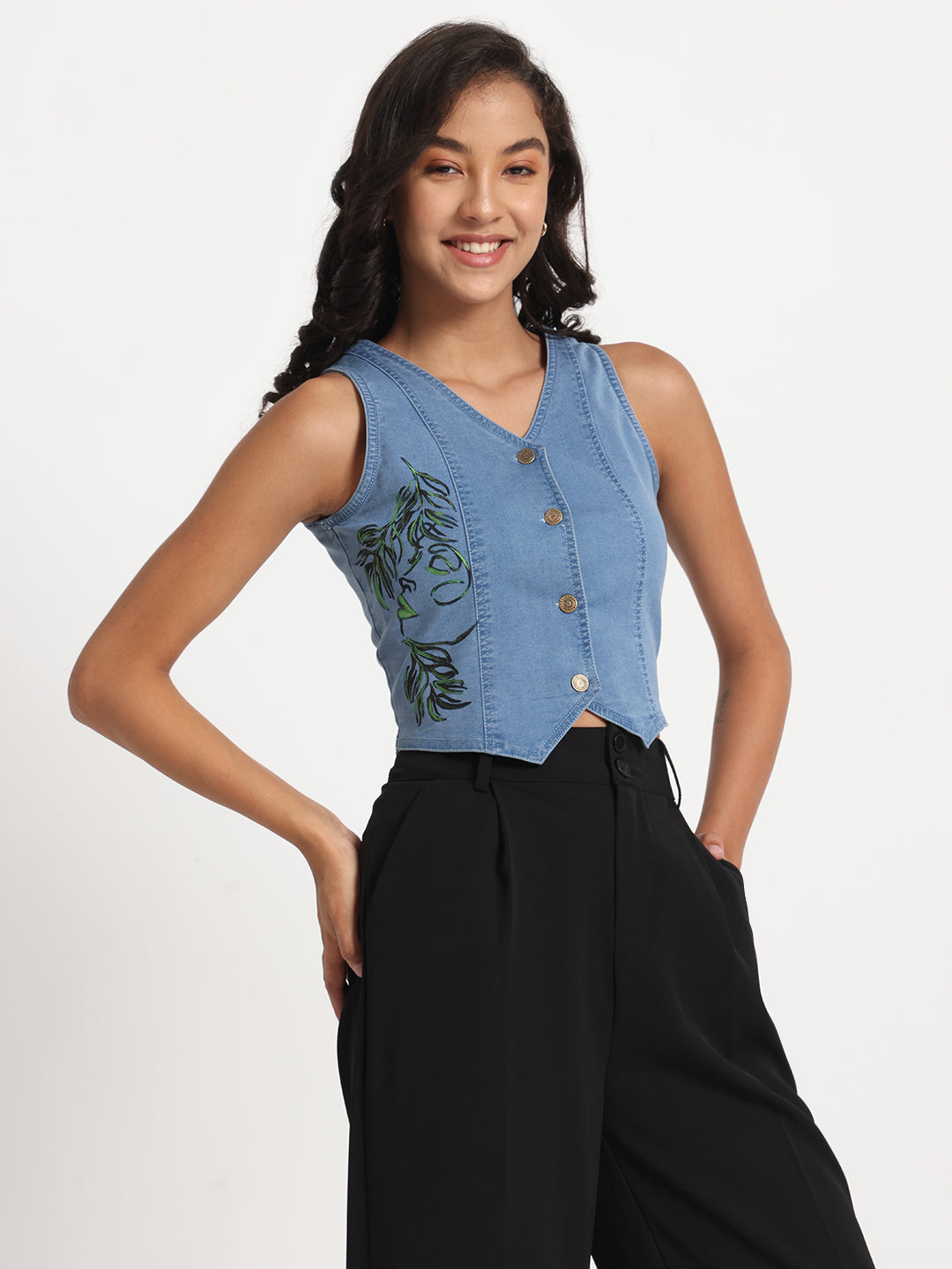 Gotamoda sleeveless blue jeans top with buttons and leaf embroidery worn with black pants