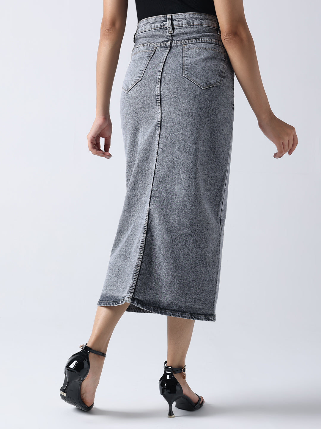 Back view of poetic rose hand Painted denim skirt in faded black worn with black heels