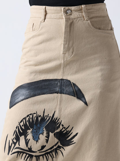 Pop Art Glam Hand Painted Denim Skirt in beige featuring a large black and blue eye design on the front