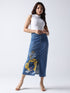 Woman wearing Gotamoda queen bee denim midi skirt with graphic print and front slit paired with white sleeveless top