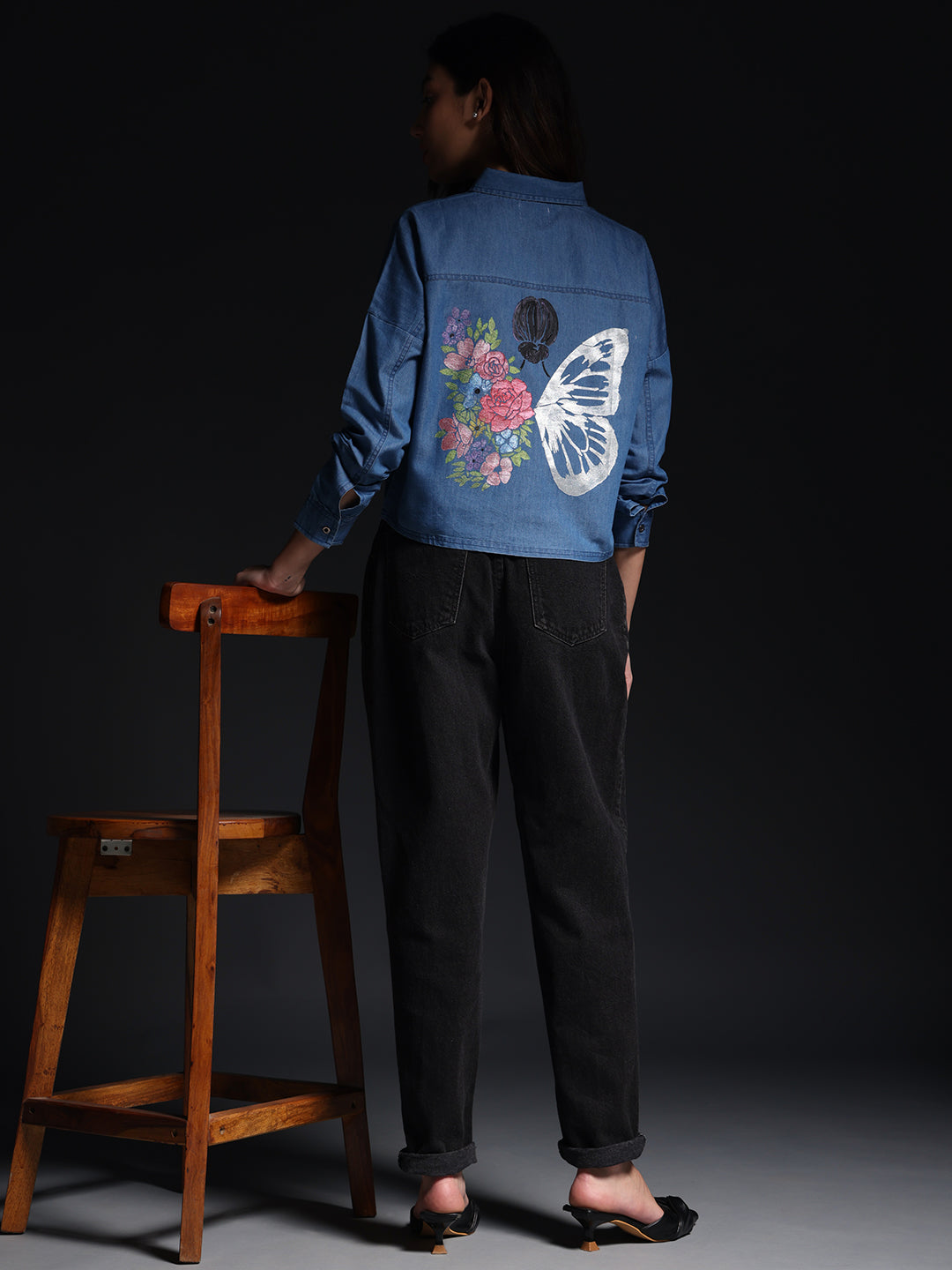 Gotamoda top jeans shirt with butterfly and floral print on back worn by woman with black pants