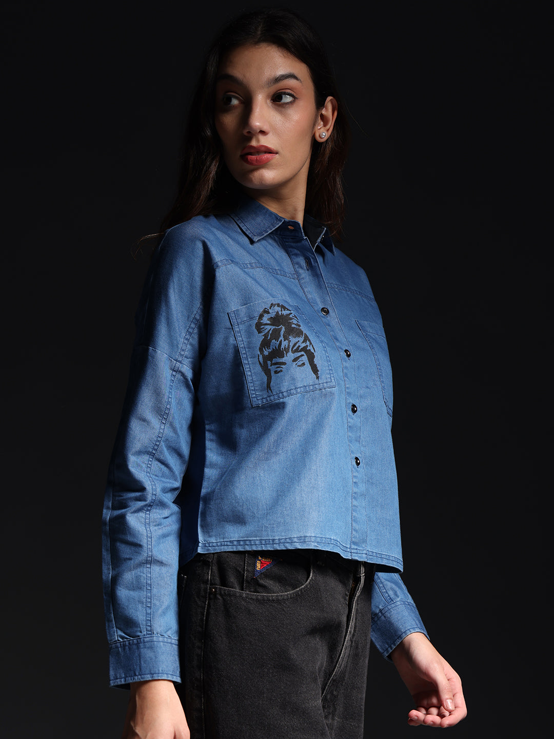 Gotamoda top jeans shirt in light blue denim with a printed pocket detail worn by a woman
