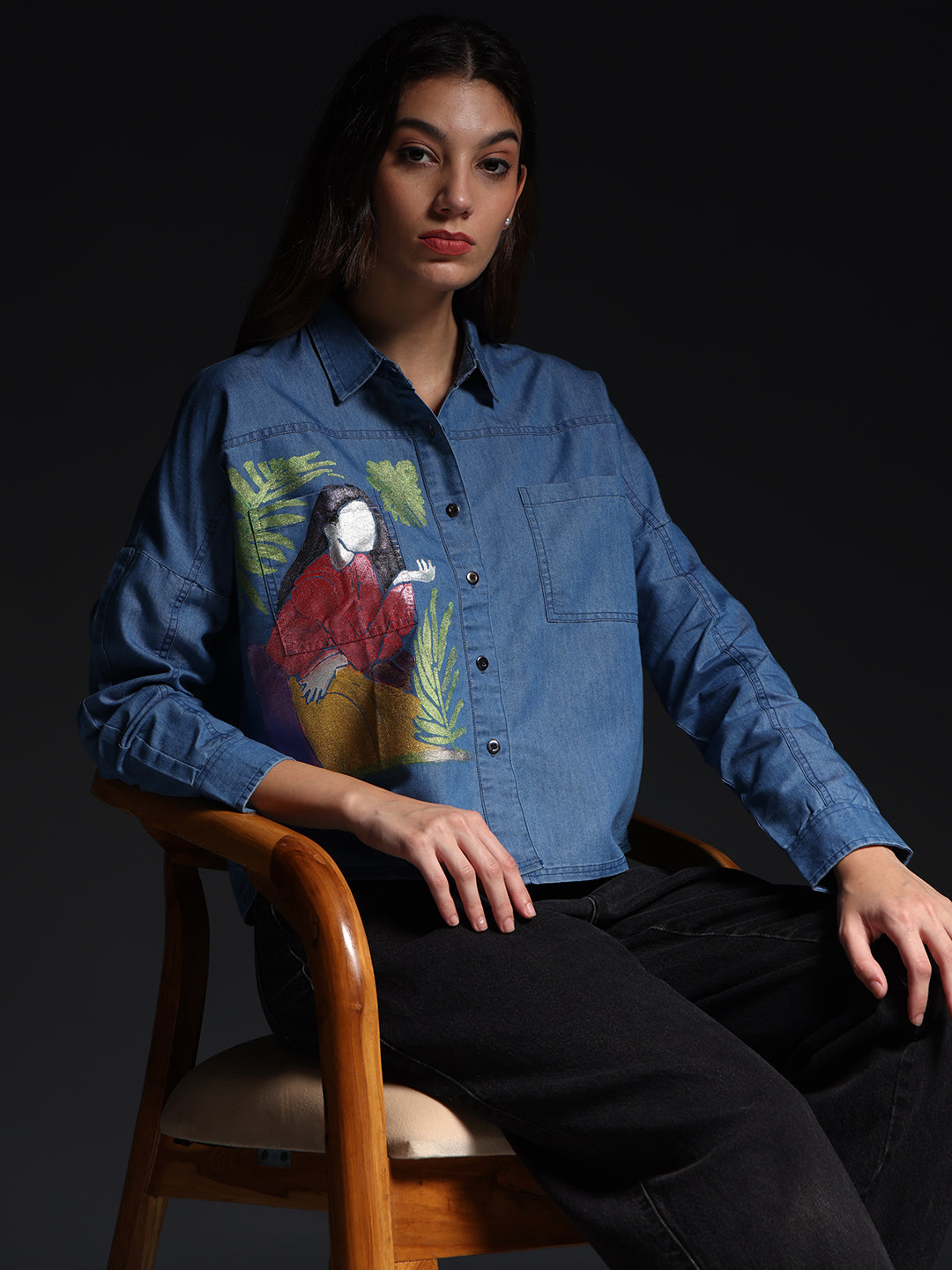 Gotamoda Top Jeans Shirt with artistic colorful print worn by seated woman with black pants