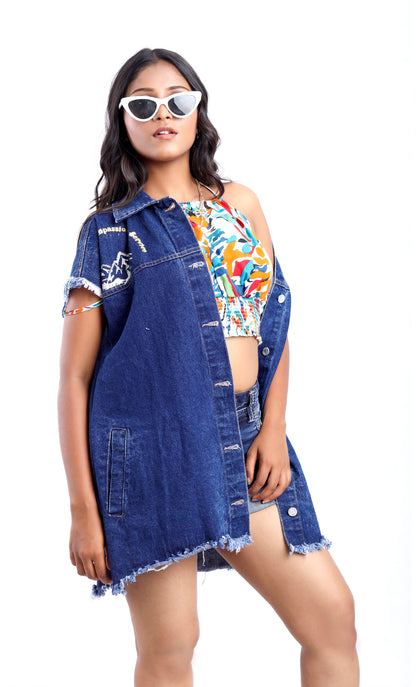 Gotamoda sleeveless denim jacket in dark blue worn over colorful crop top and shorts