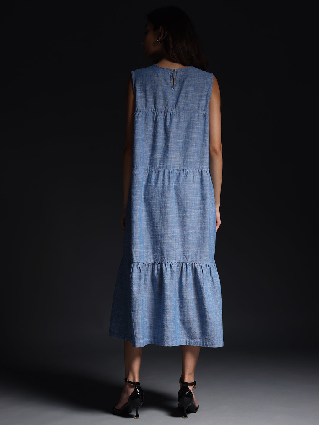 Gotamoda sleeveless maxi dress in blue checked pattern shown from the back with tiered design